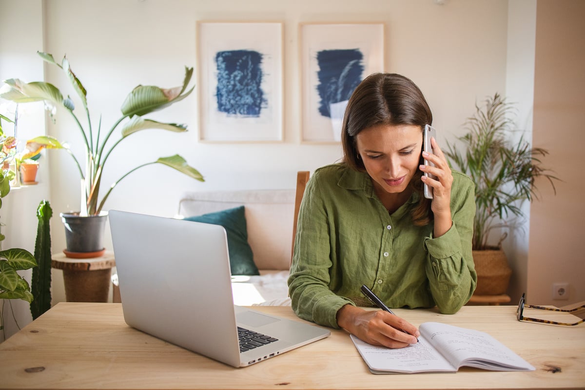 Woman Working from Home Talking on the Phone