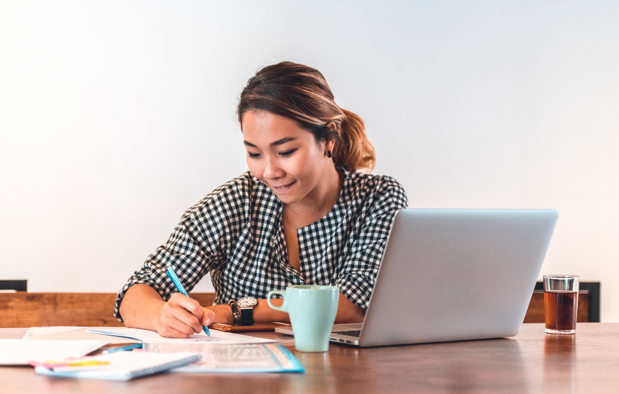 Young woman calculating monthly budget at home